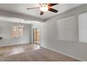 Open living room with ceiling fan, tile and carpet flooring and sliding glass door at 935 E Redondo Dr, Gilbert, AZ 85296