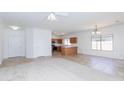 Bright and open-concept living space with fresh neutral paint, tile flooring, and modern lighting at 10038 E Keats Ave, Mesa, AZ 85209