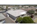 Aerial view of a well-maintained home with a tiled roof, covered patio, and desert landscaping at 11003 E Kiva Ave, Mesa, AZ 85209