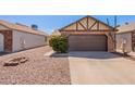 Cozy one-story house features a neatly maintained yard and a convenient two-car garage at 1247 W Boxelder Cir, Chandler, AZ 85224