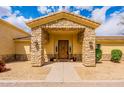 Home's entryway with stone pillars and wood front door at 1438 E Mesquite St, Gilbert, AZ 85296