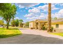 Inviting single story home with a well-manicured lawn and stone accents on the entry and lower portion of the exterior at 1438 E Mesquite St, Gilbert, AZ 85296