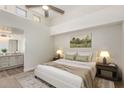 Serene main bedroom features high ceilings, a ceiling fan, and an ensuite bath at 14458 W Zuni Trl, Surprise, AZ 85374