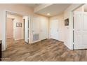 Inviting hallway with wood flooring, neutral walls, and multiple doors for easy access at 14950 W Mountain View Blvd # 7309, Surprise, AZ 85374