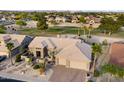 Aerial view of a home next to a golf course, showcasing its desert landscaping and neighborhood at 15109 W Waterford Dr, Surprise, AZ 85374
