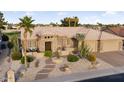 Expansive exterior view featuring desert landscaping, a spacious driveway, and a two-car garage at 15109 W Waterford Dr, Surprise, AZ 85374