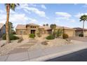 Charming front exterior featuring desert landscaping and beautiful architectural details on a sunny day at 15109 W Waterford Dr, Surprise, AZ 85374