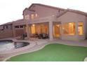 Backyard features a private pool, covered patio with lounge seating, and manicured landscaping at 15229 S 18Th Dr, Phoenix, AZ 85045