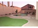 Private backyard oasis featuring a kidney-shaped pool, artificial turf, and desert landscaping at 15229 S 18Th Dr, Phoenix, AZ 85045