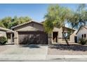 Attractive single-Gathering home with a two-car garage and mature landscaping at 16188 W Boca Raton Rd, Surprise, AZ 85379