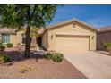Charming single-story home with a desert landscape and a two-car garage at 20627 N Lemon Drop Dr, Maricopa, AZ 85138