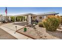 Quaint home featuring covered parking and beautifully landscaped front yard at 215 N Power Rd # 340, Mesa, AZ 85205