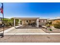 Inviting home with covered parking, outdoor seating, and decorative landscaping at 215 N Power Rd # 340, Mesa, AZ 85205