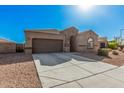 Attractive single-story home with a two-car garage, desert landscaping, and a welcoming facade at 23805 W Romley Ave, Buckeye, AZ 85326
