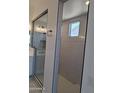 Bright bathroom featuring a large glass-enclosed shower with modern vertical tiling, rain showerhead, and ample lighting at 24152 N 172Nd Ave, Surprise, AZ 85387