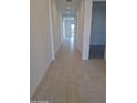 Bright hallway with tiled floors and modern white walls leading to various rooms at 24152 N 172Nd Ave, Surprise, AZ 85387
