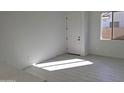 Bright room with tiled flooring, large window, and a white door at 24152 N 172Nd Ave, Surprise, AZ 85387