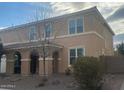 Charming two-story home boasts a covered front porch and easy-care landscaping at 24228 S 211Th St, Queen Creek, AZ 85142