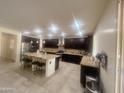 Spacious kitchen with dark wood cabinets, granite countertops, and stainless steel appliances at 24228 S 211Th St, Queen Creek, AZ 85142
