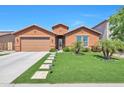 Charming single-story home with a well-manicured lawn, beautiful landscaping, and a two-car garage at 2468 W Dapple Gray Ct, San Tan Valley, AZ 85144