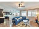 Inviting living room with an open floor plan, a plush blue sectional, and plenty of natural light at 2468 W Dapple Gray Ct, San Tan Valley, AZ 85144