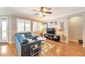 Cozy living room featuring a comfortable blue sectional, modern decor, and plenty of natural light at 2468 W Dapple Gray Ct, San Tan Valley, AZ 85144