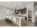 Bright, open kitchen features a large island with bar seating and stylish pendant lighting at 26699 N 104Th Way, Scottsdale, AZ 85262