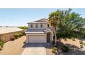 Beautiful two-story home with a desert landscaped front yard, mature trees, and a two-car garage at 29051 N Shannon Dr, San Tan Valley, AZ 85143