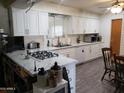 Well-lit kitchen with white cabinets, updated countertops and modern appliances, a chef's delight at 3141 W Joan De Arc Ave, Phoenix, AZ 85029