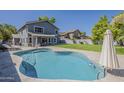 A beautiful pool highlights the backyard of this modern two-story home in a suburban community at 3252 E Lexington Ave, Gilbert, AZ 85234