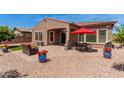 Outdoor patio with comfortable seating, dining area, and a charming red umbrella at 3269 E Ironside Ln, Gilbert, AZ 85298