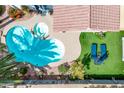 Aerial view of a backyard featuring a freeform pool, spa, patio and lounge area at 4061 W Tonopah Dr, Glendale, AZ 85308
