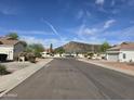 Wide street view, capturing the neighborhood's serene environment and desert landscaping at 4061 W Tonopah Dr, Glendale, AZ 85308