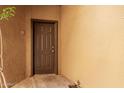 Close up of a solid, 6-panel exterior door with brown paint and silver hardware and a small overhang at 4644 N 22Nd St # 1137, Phoenix, AZ 85016