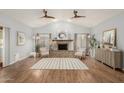 Bright living room with vaulted ceiling, cozy fireplace, and wood-look flooring at 4747 N 84Th Way, Scottsdale, AZ 85251