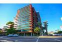 Contemporary high-rise with multiple stories, red and orange detail, and an open view of the bright blue sky at 4808 N 24Th St # 527, Phoenix, AZ 85016