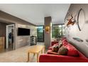 Inviting living room with modern furnishings, plush red sofa, neutral tones, and large windows at 4808 N 24Th St # 527, Phoenix, AZ 85016