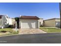 Charming single-story home with a two-car garage, tile roof, and well-manicured front lawn at 562 S Palo Verde Way, Mesa, AZ 85208