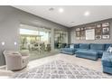 Bright living room with plush sectional sofa and seamless indoor-outdoor flow to backyard at 5639 S Four Peaks Pl, Chandler, AZ 85249