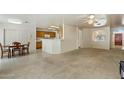 Bright living room with large windows, tile flooring near dining area, and open floor plan at 63 W Los Arboles Dr, Tempe, AZ 85284