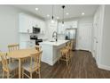 Bright kitchen features a center island, stainless steel appliances, and wood flooring at 7531 E Billings St # 123, Mesa, AZ 85207