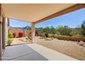 Backyard featuring desert landscaping and a covered patio with mountain views at 10351 E Morning Star Dr, Scottsdale, AZ 85255
