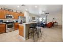 Open kitchen with stainless steel appliances and breakfast bar, flowing into the living area at 12425 W Jefferson St, Avondale, AZ 85323
