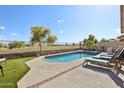 Inviting backyard pool with lounge chairs and views of the golf course at 12425 W Jefferson St, Avondale, AZ 85323