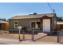 Front exterior of a single-story home with a chain-link fence and grey painted stucco at 1424 S Bonarden Ln, Tempe, AZ 85281