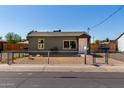 An exterior view of a single-Gathering home with a fenced yard and street view at 1424 S Bonarden Ln, Tempe, AZ 85281