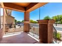 View from the porch showing decorative iron railings and views of the landscaped front yard at 1690 E Desert Breeze Ct, Casa Grande, AZ 85122