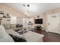 Inviting living room with vaulted ceilings, wood floors, and a stylish sectional sofa at 1736 E Villa Maria Dr, Phoenix, AZ 85022