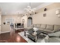 Open-concept living area with stylish furniture, including a comfortable sectional and modern lighting at 1736 E Villa Maria Dr, Phoenix, AZ 85022