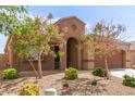 Inviting single-story home featuring a cozy porch and desert landscaping in the front yard at 19887 N Herbert Ave, Maricopa, AZ 85138